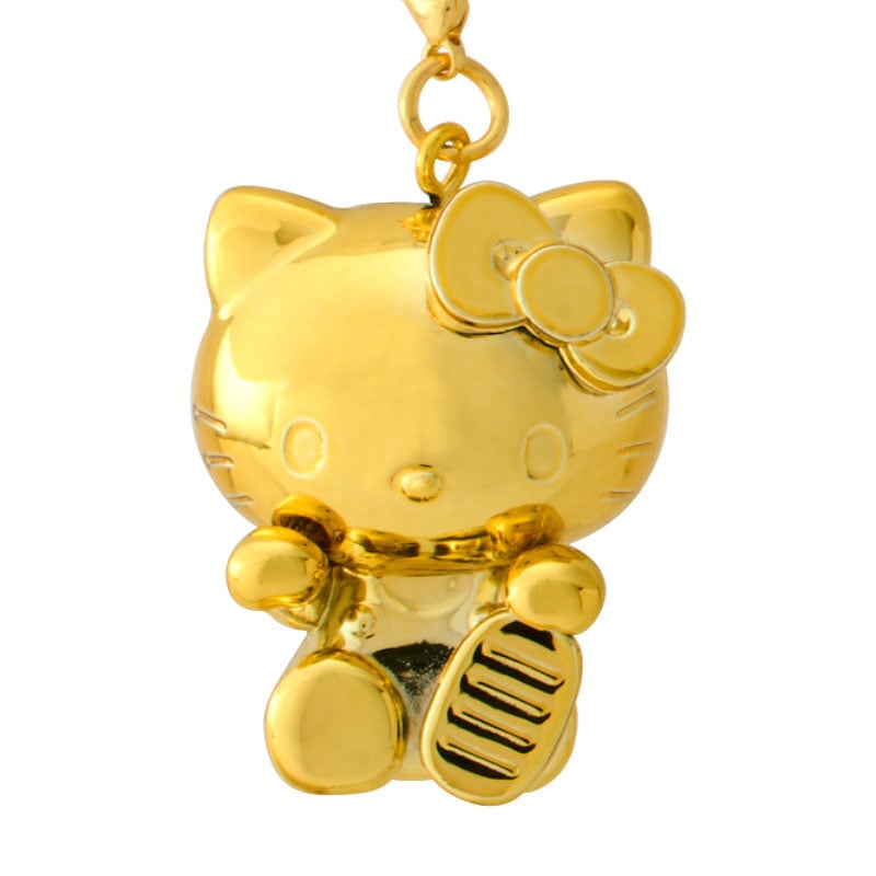 Hello Kitty charm attached to a denim bag strap for everyday luck