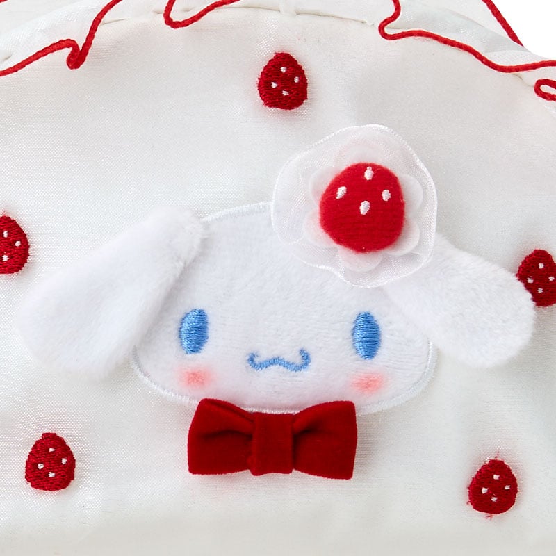 Cinnamoroll pouch shown inside a travel tote with accessories