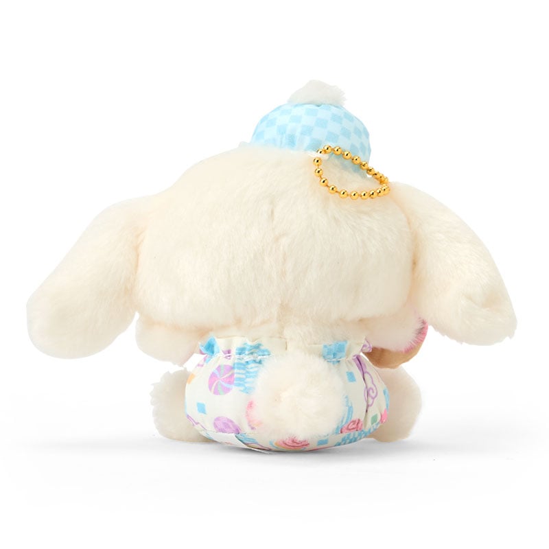 Cinnamoroll plush keychain hanging from a denim tote bag in natural light