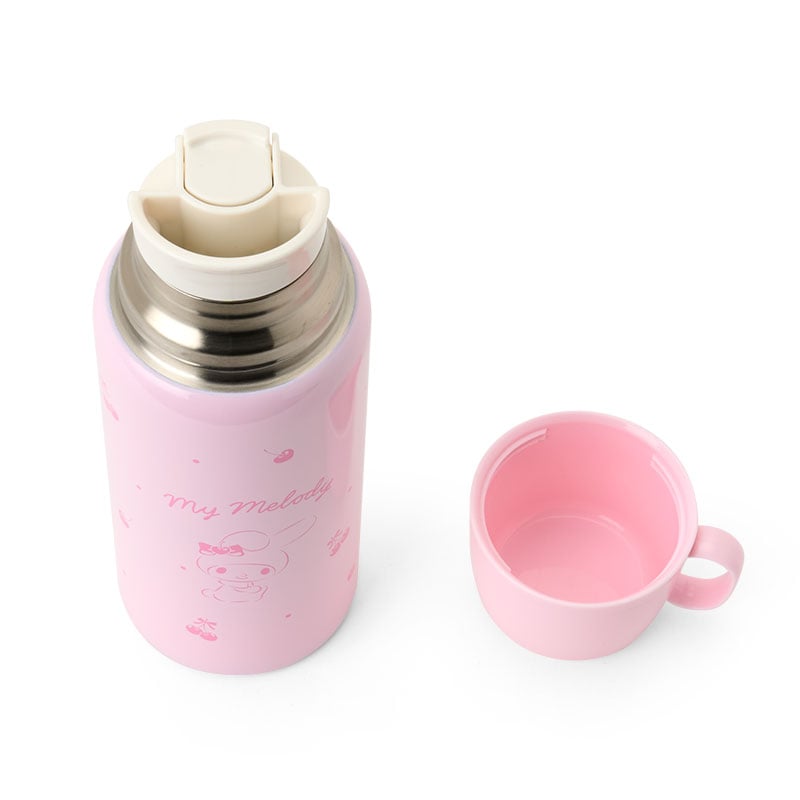 Front view of My Melody stainless steel bottle with carrier on a picnic bench