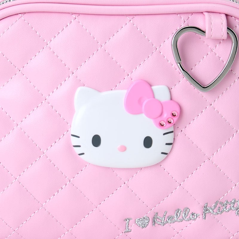 Close-up of the Hello Kitty pouchs quilted design and heart-shaped keyring