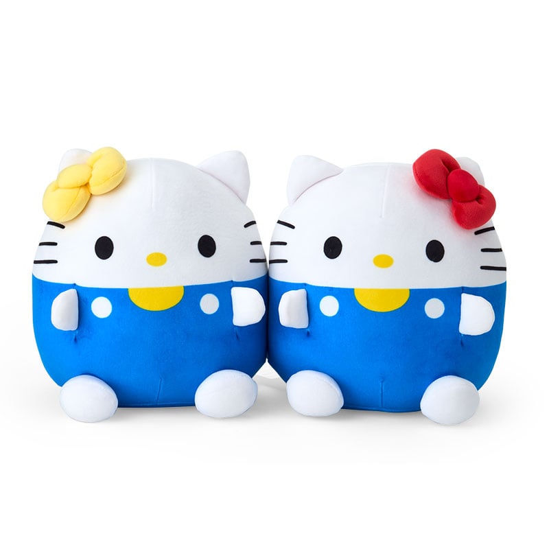 Hello Kitty and Mimmy throw pillows displayed on a cozy bed