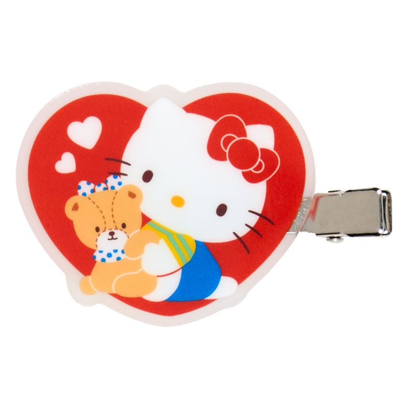 Hello Kitty mini hair clips being used to keep hair back while applying makeup, showcasing their practicality.