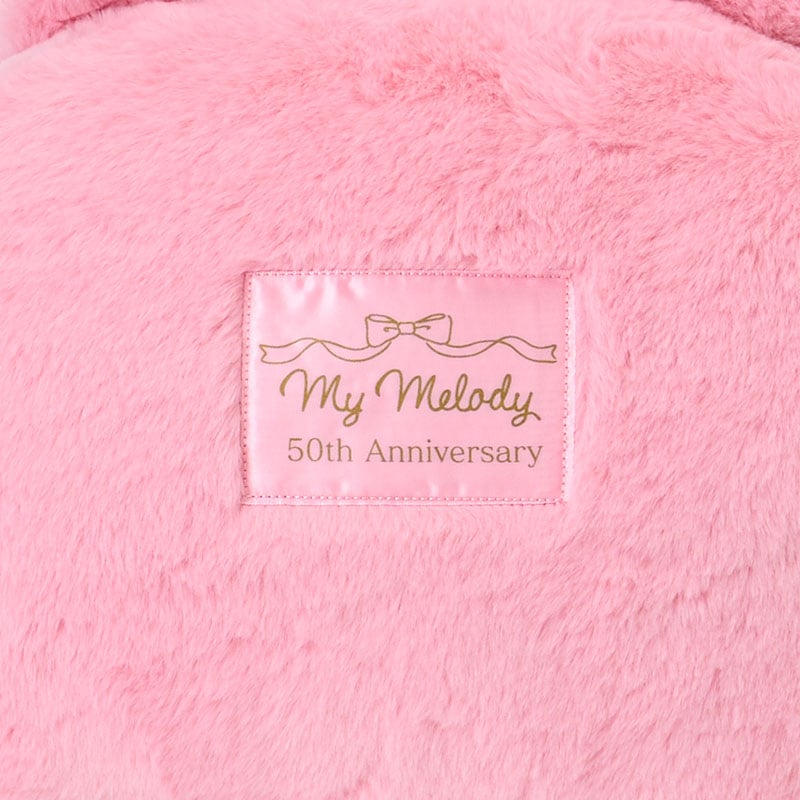 My Melody plush with oversized ribbon detail in a cozy setting