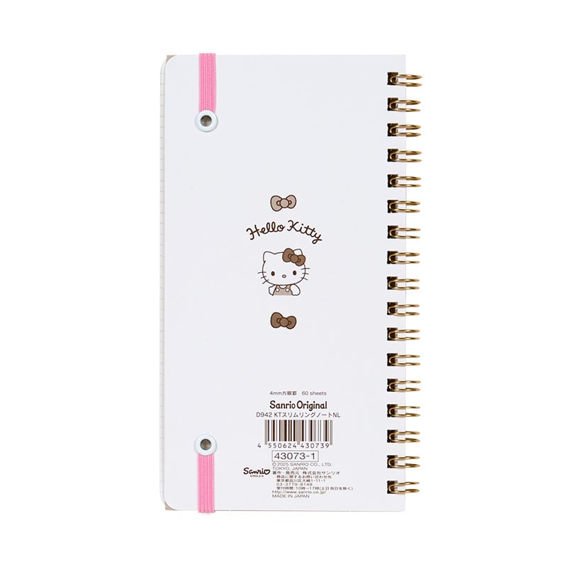 Close-up of Hello Kitty spiral notebook showcasing elastic closure and character design.