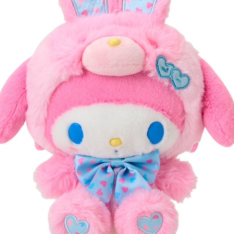 Close-up of bunny plush with embroidered eyes, soft mocha fur, and hand-painted cheeks