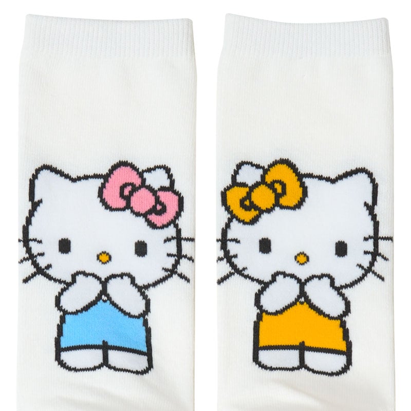 Close-up of Hello Kitty crew socks showing left and right Sanrio character heel designs