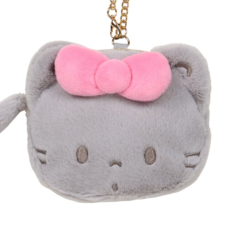 Close-up of the cat tail zipper pull and embroidered details on the pouch