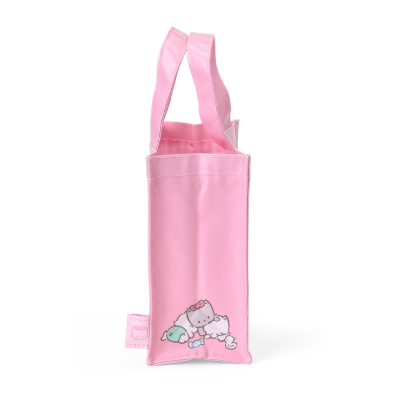 Mini tote bag styled with matching plush charm for a casual outing