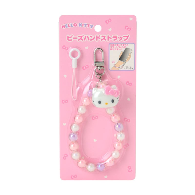 Close-up of the beaded charm with beads and mini mascot on a smartphone case