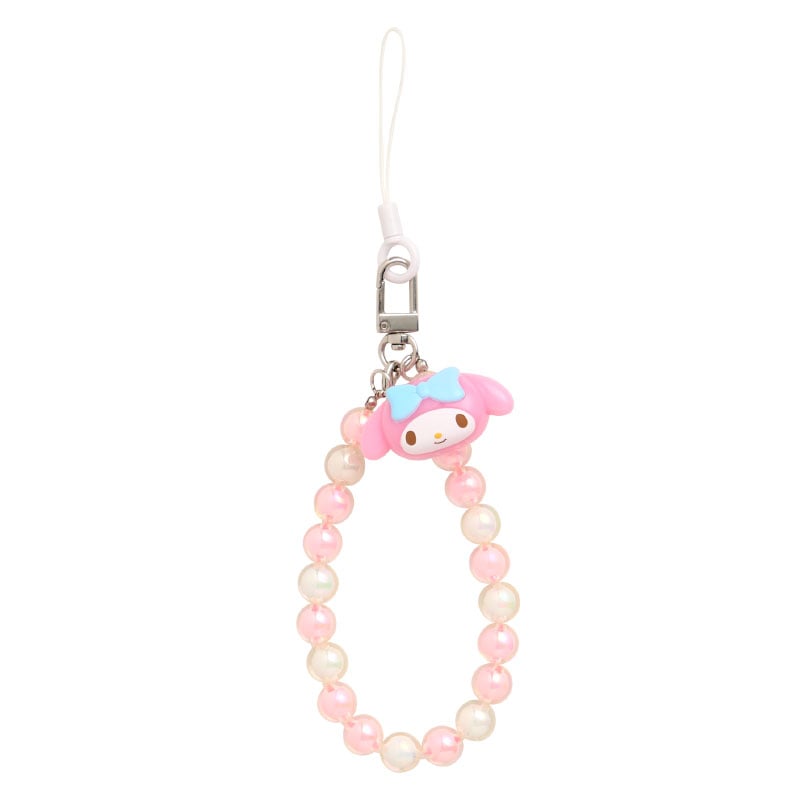 Beaded My Melody phone charm hanging from iPhone case in Tokyo café light