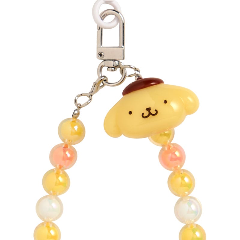 Sanrio-themed phone charm attached to a digital camera during outdoor use