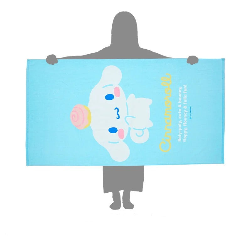 Cinnamoroll Delight Egyptian Cotton Bath Towel spread out on a sandy beach