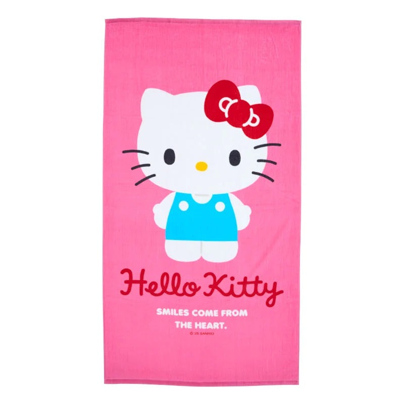 Hello Kitty towel laid out on the sand at the beach