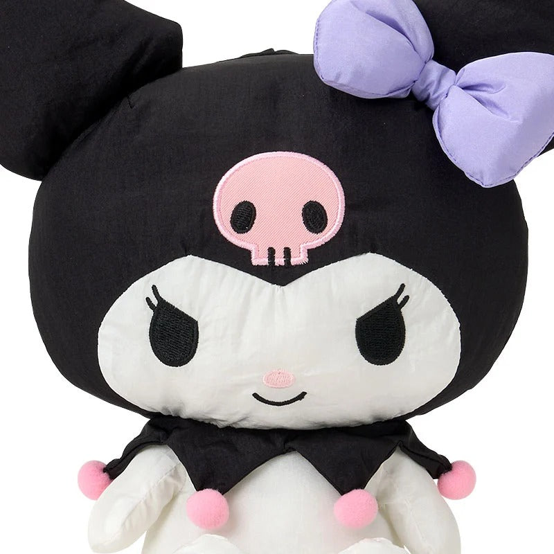 Side view of the Kuromi plush doll on a colorful shelf.