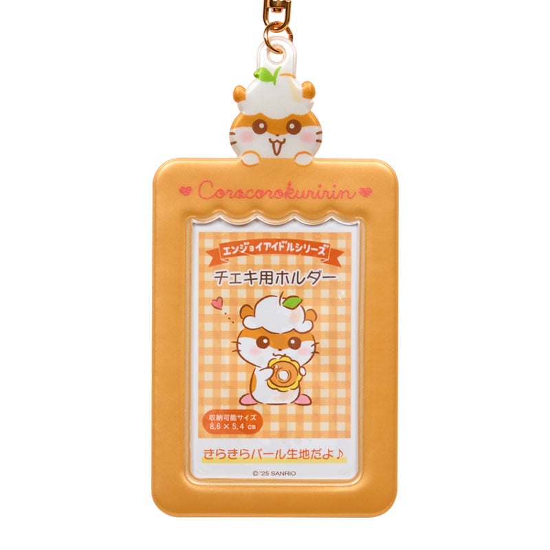 Flat lay of the photo card holder charm with a trading card and a keychain.