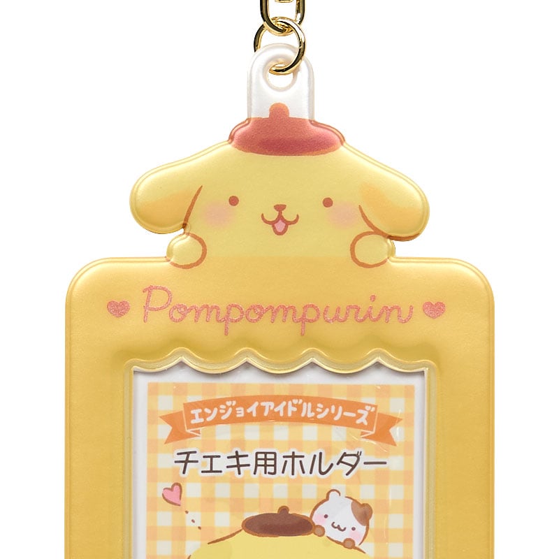 Sanrio merchandise featuring Pompompurin displayed on a bag with a photo holder stand