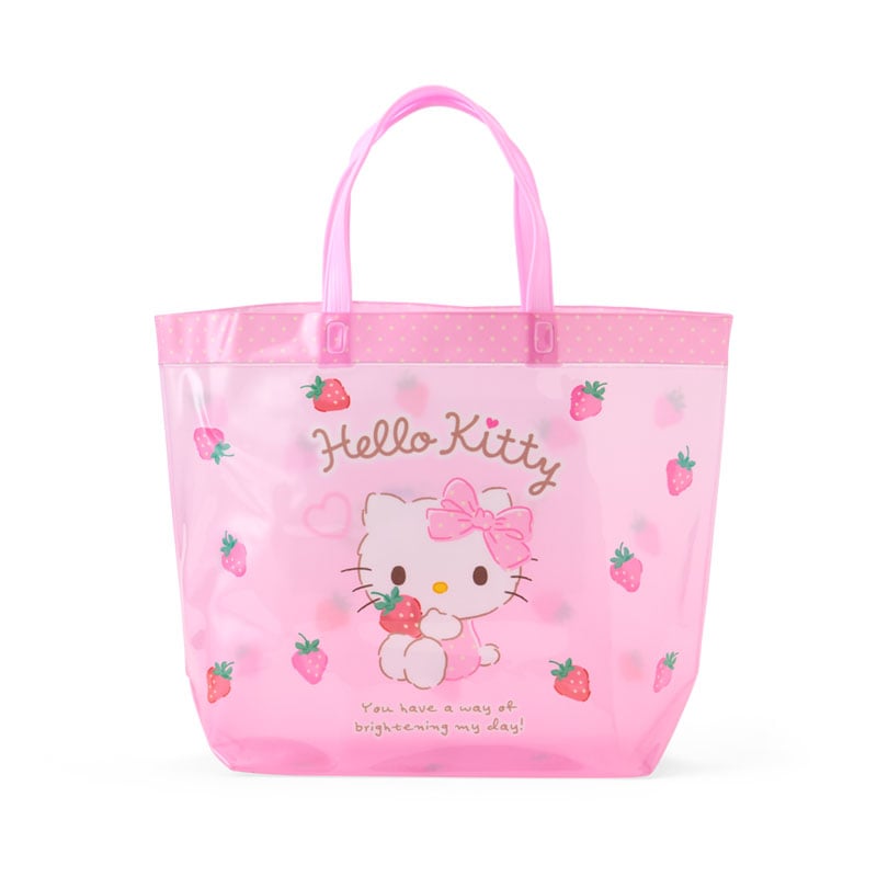 Hello Kitty clear vinyl tote bag displayed outdoors, suitable for beach trips.