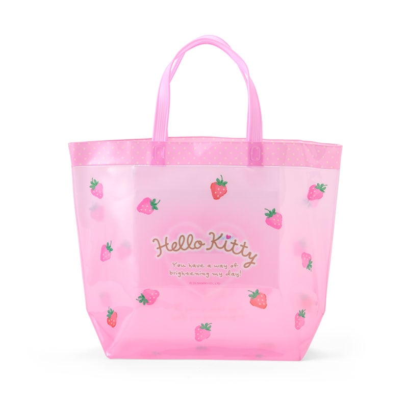 Hello Kitty clear vinyl tote bag displayed outdoors, suitable for beach trips.