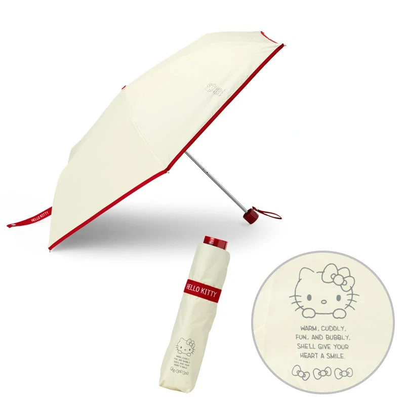 Hello Kitty umbrella open beside suitcase for weekend travel
