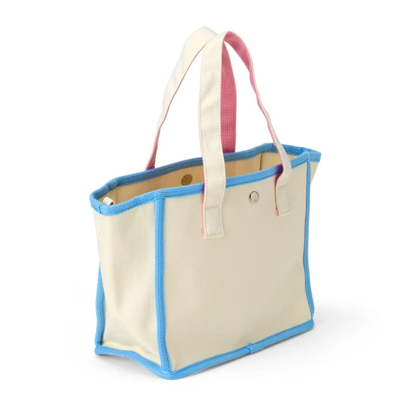 Front angle of Cinnamoroll tote showing embroidered design and top handles