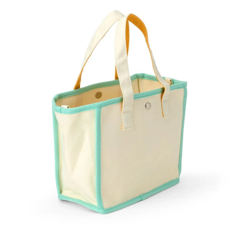 Pochacco tote bag carried by hand, showcasing its stylish design