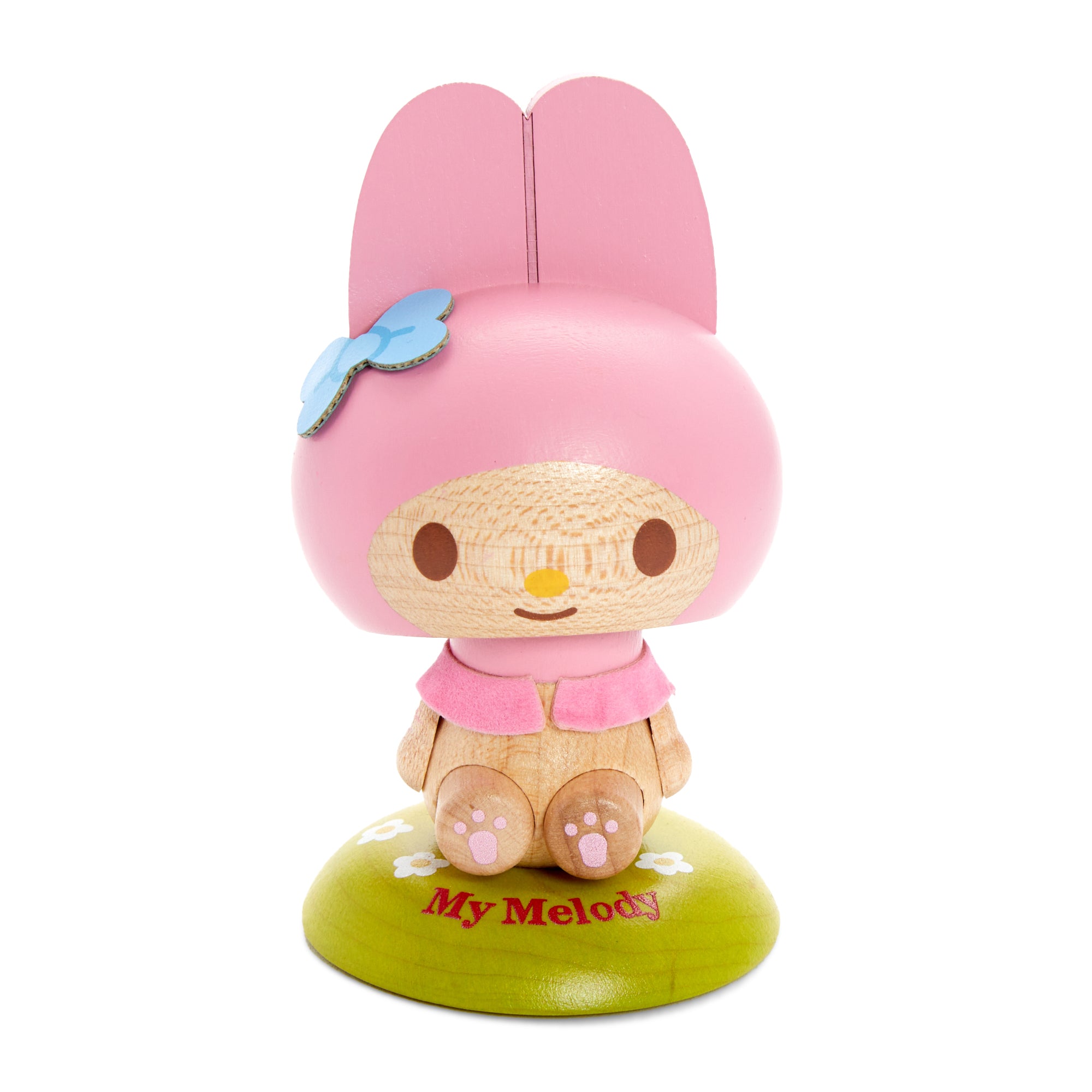 My Melody bobblehead displayed on a wooden desk, nodding playfully