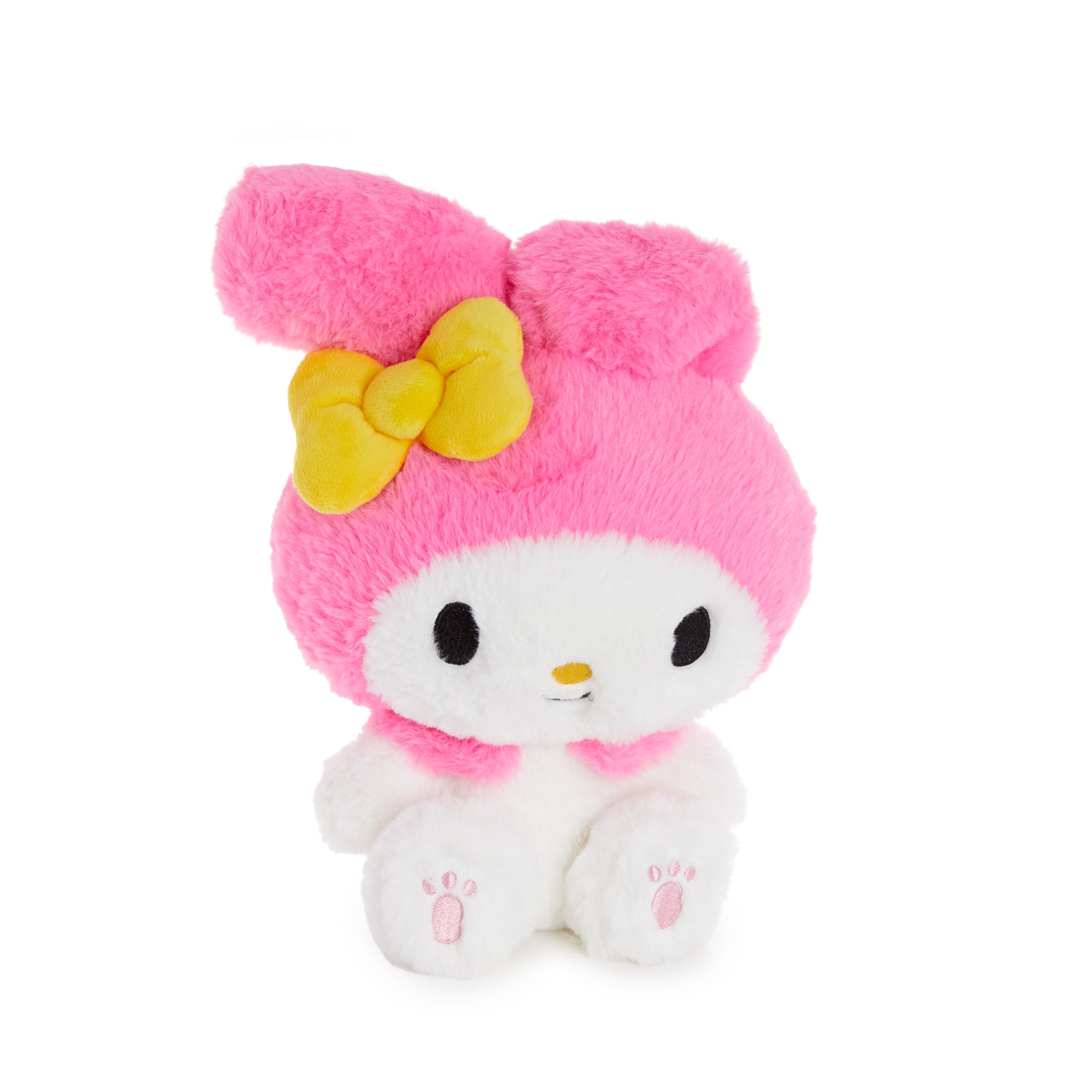 My Melody plush toy sitting on a cozy bed, showcasing its soft fur.