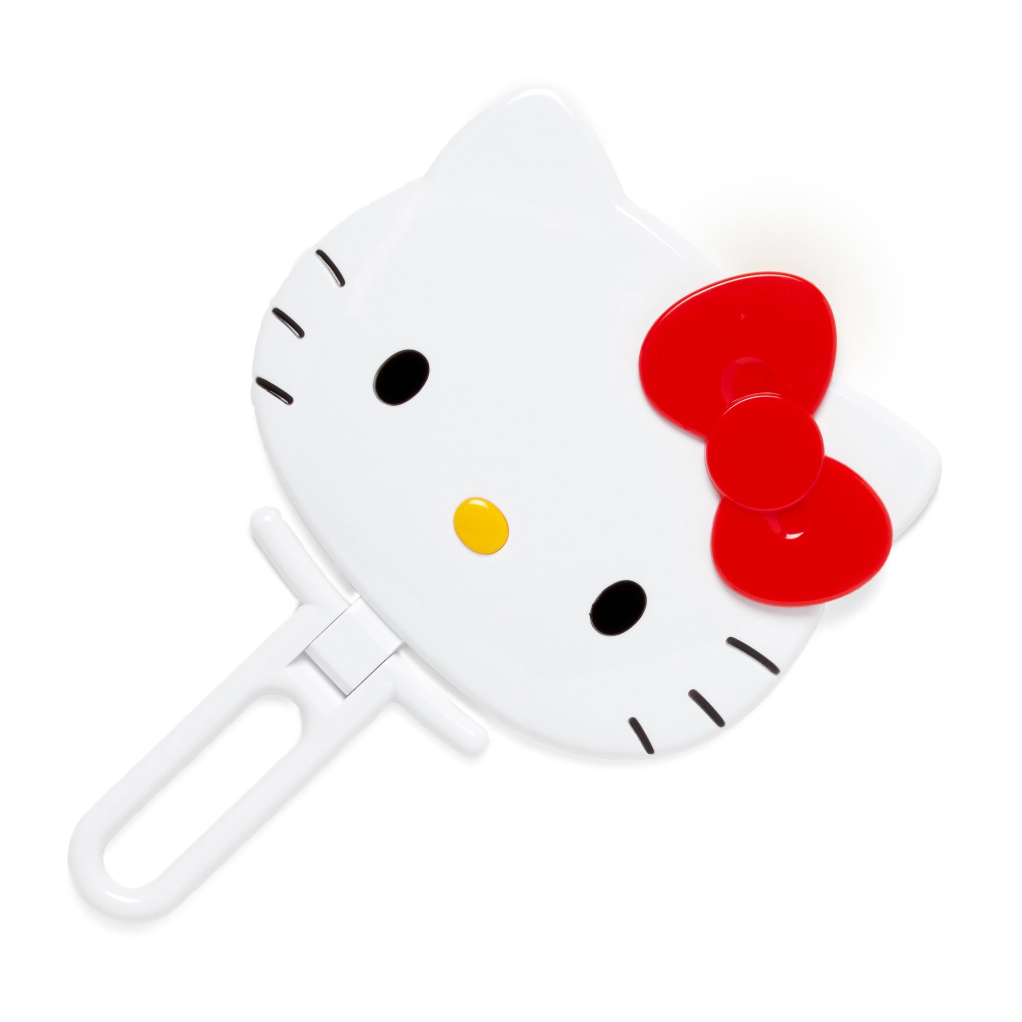Hello Kitty folding hand mirror with character design on a vanity table