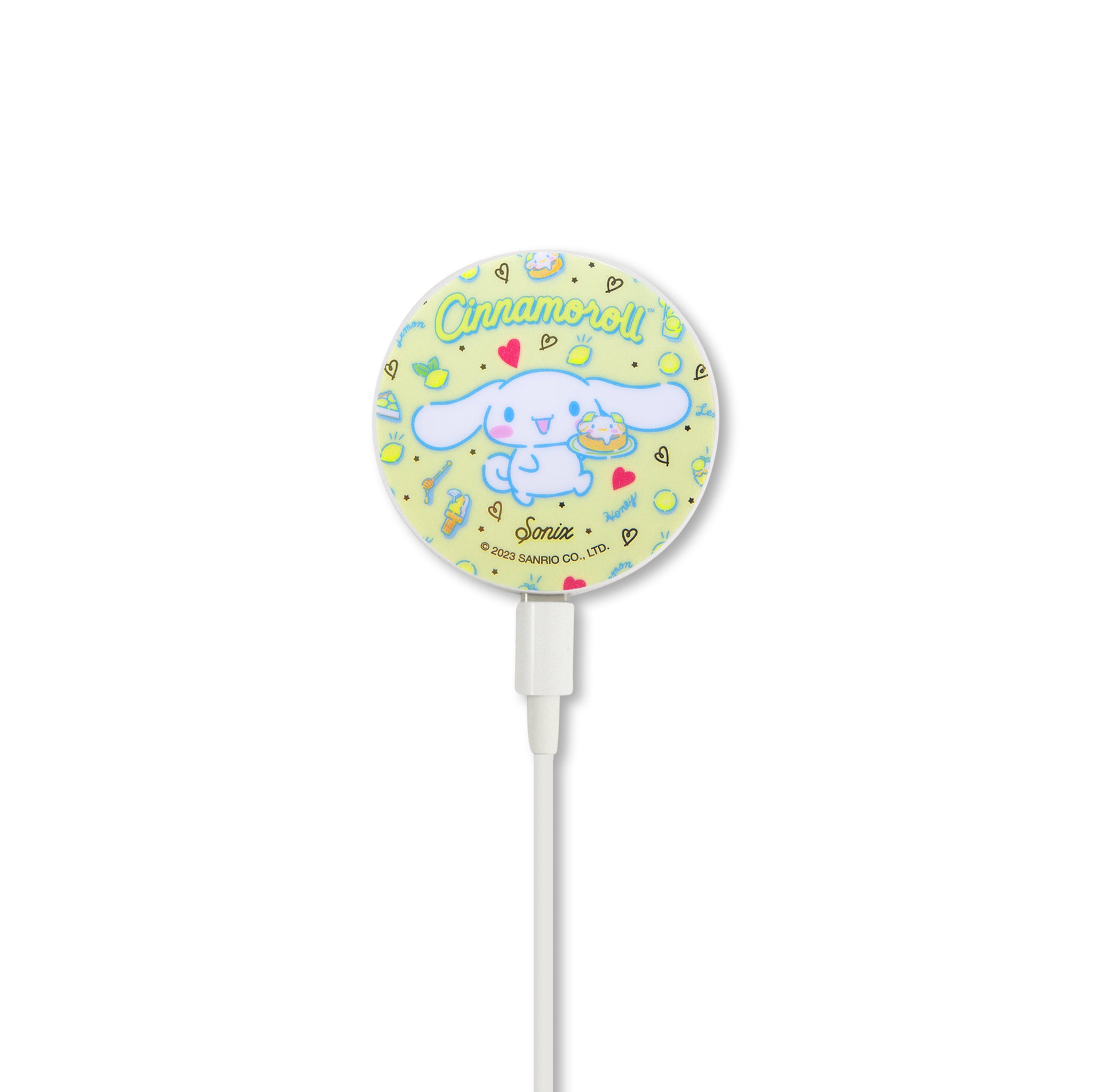Wireless charger in use, charging an iPhone with a protective case featuring Cinnamoroll design