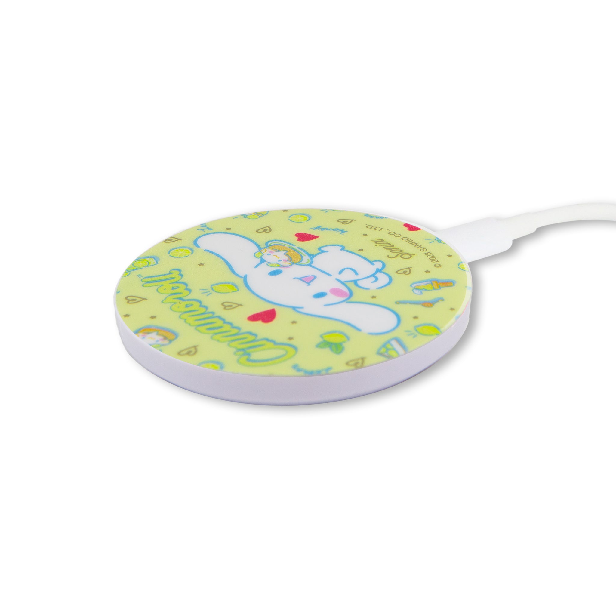 Wireless charger in use, charging an iPhone with a protective case featuring Cinnamoroll design