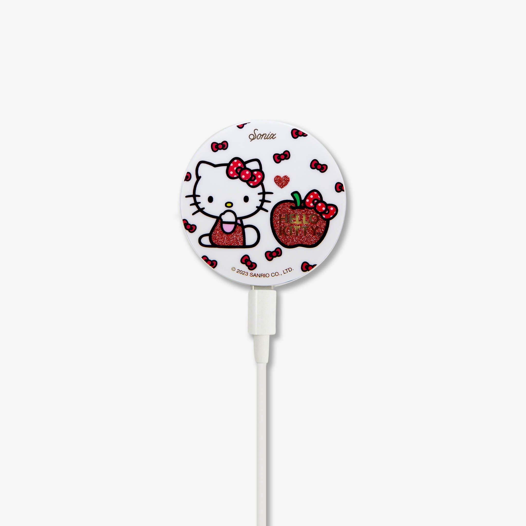 iPhone 14 charging on the Hello Kitty charger, showcasing its design.