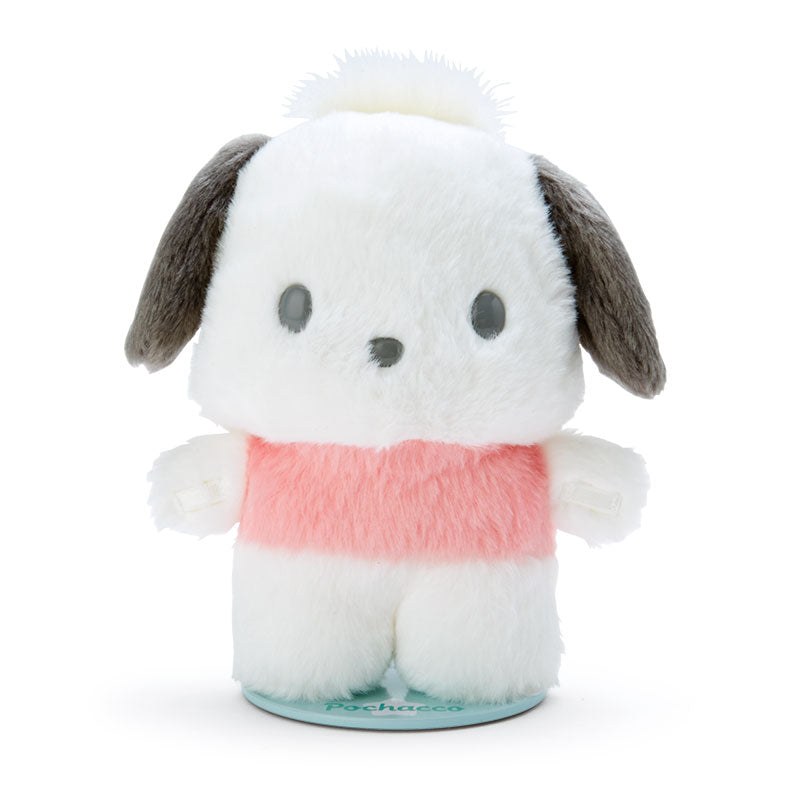 Front view of Pochacco plush on a desk with a book behind it.