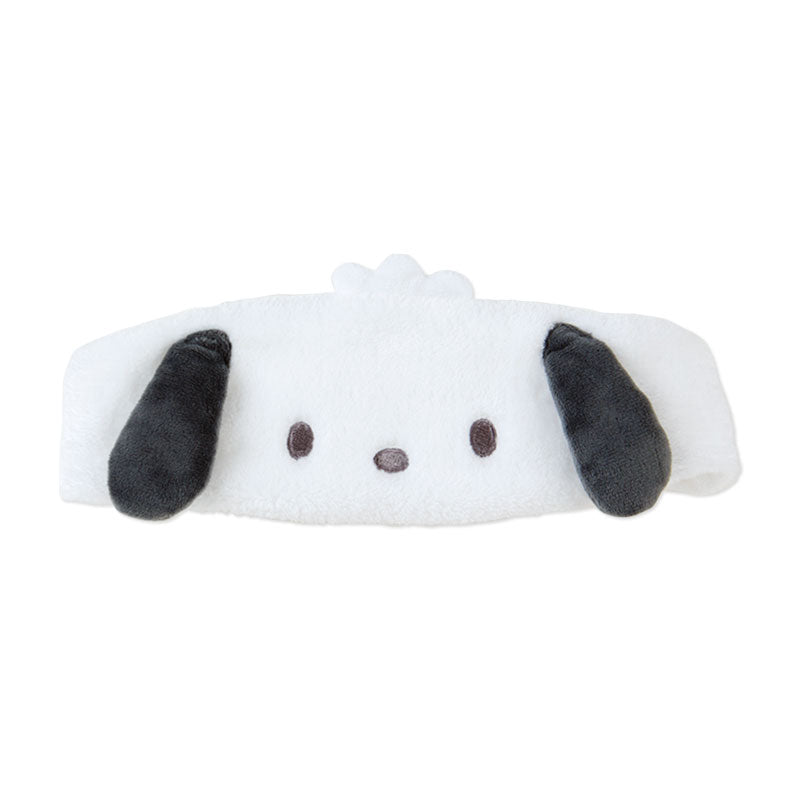 Pochacco Sanrio headband styled with skincare products on a marble table