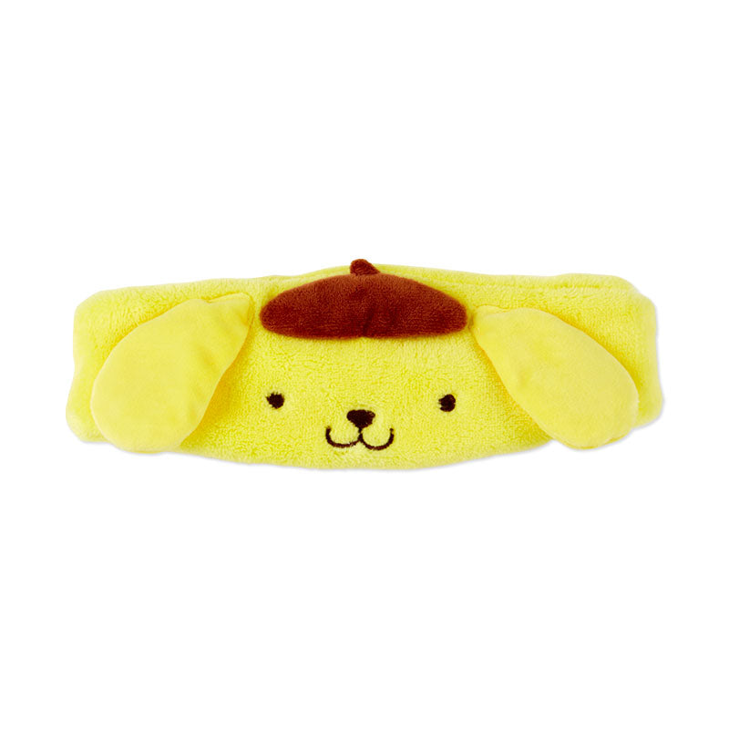 Close-up of embroidered Pompompurin plush headband on bathroom counter