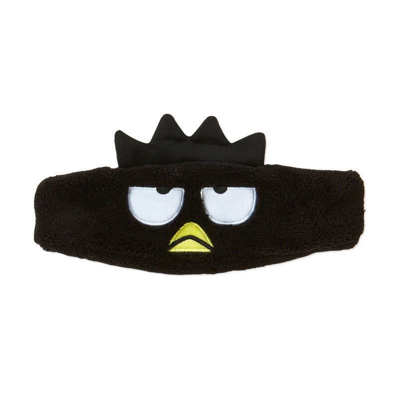 Badtz-Maru plush headband modeled on a vanity table with makeup brushes