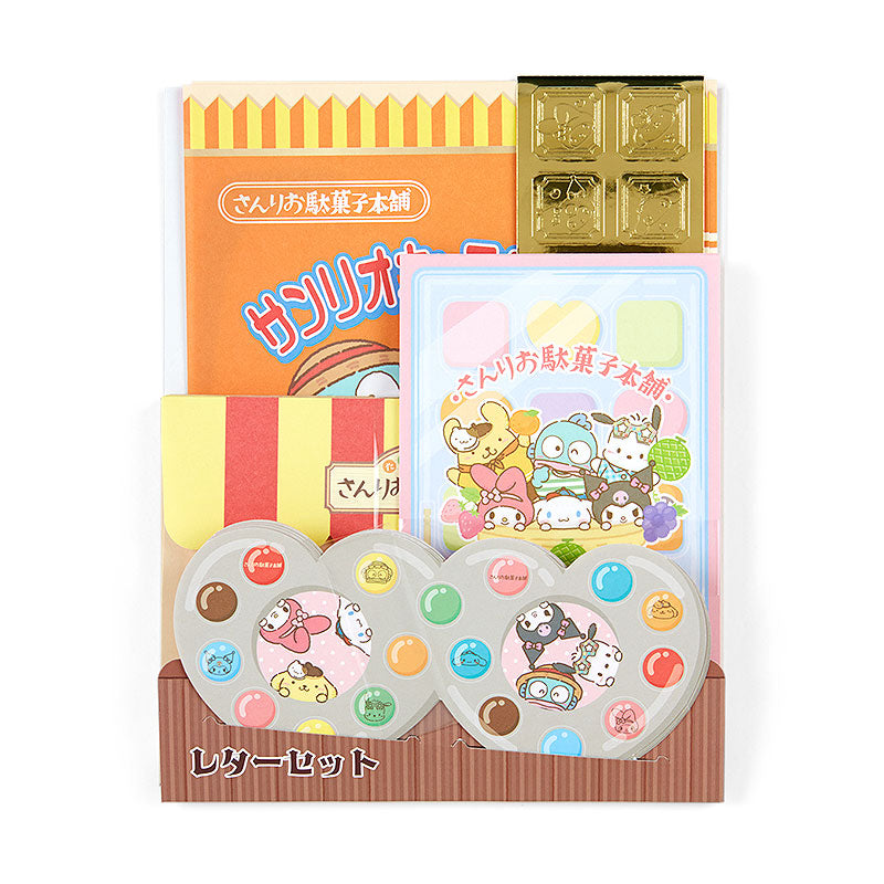 Front view of Sanrio stationery set showing all sheets, envelopes, and gold seals