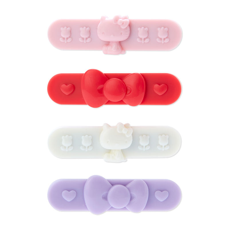 Close-up of mini flower hair clips with Hello Kitty designs on light brown hair